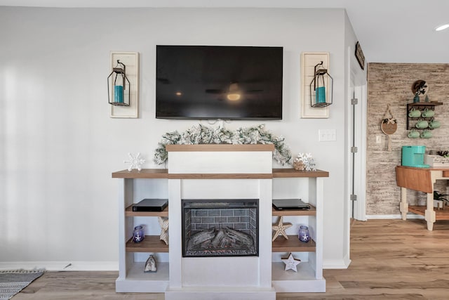 215 Meadow Brook Ln Unit 1, Branson, MO 65616 - details featuring baseboards, wood finished floors, and a fireplace