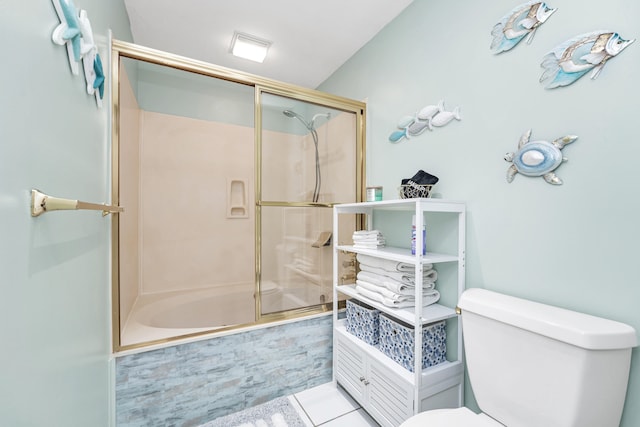 bathroom with enclosed tub / shower combo, tile patterned flooring, and toilet