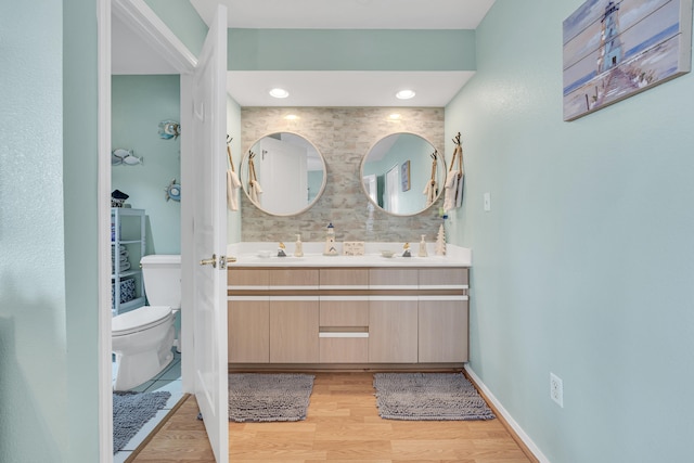 bathroom featuring vanity, hardwood / wood-style floors, and toilet