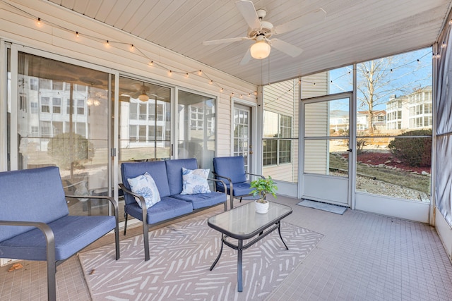 sunroom with ceiling fan and wood ceiling