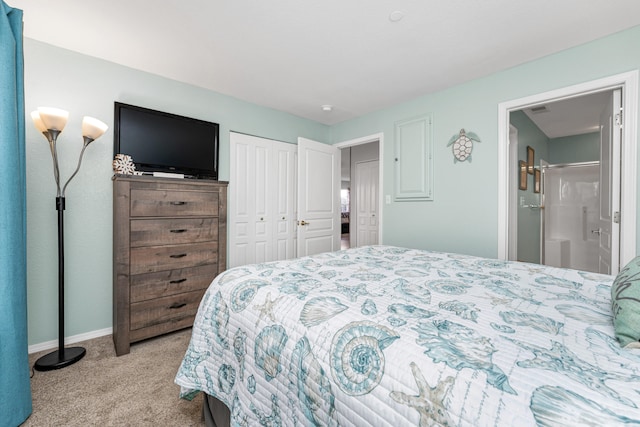 bedroom featuring light colored carpet and ensuite bathroom