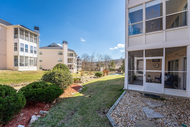 view of yard with a sunroom