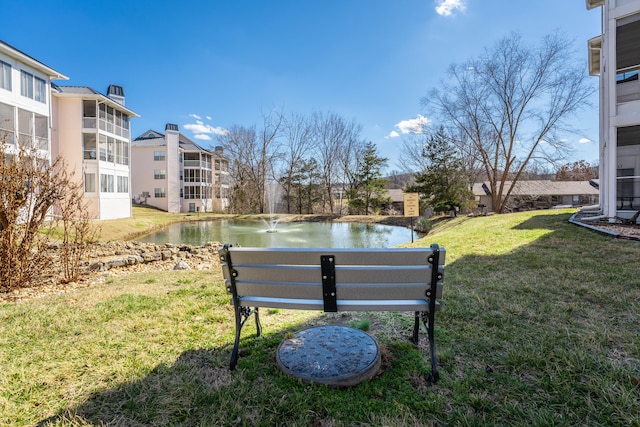 view of home's community featuring a water view and a yard