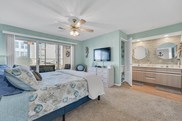 215 Meadow Brook Ln Unit 1, Branson, MO 65616 - bedroom with light carpet, light wood-type flooring, baseboards, a ceiling fan, and ensuite bath