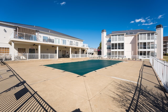 view of swimming pool featuring ceiling fan and a patio area