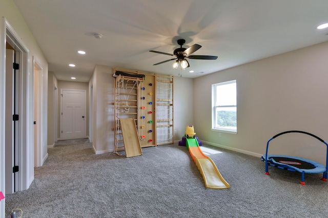 playroom featuring ceiling fan and carpet