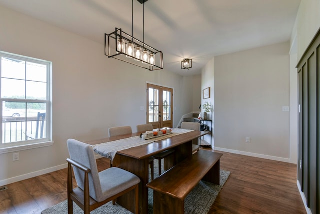 dining room with french doors, dark hardwood / wood-style flooring, and a wealth of natural light