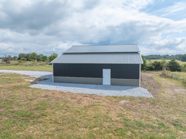 view of outbuilding with a yard