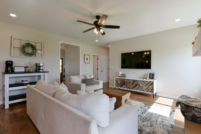 living room featuring dark hardwood / wood-style floors and ceiling fan