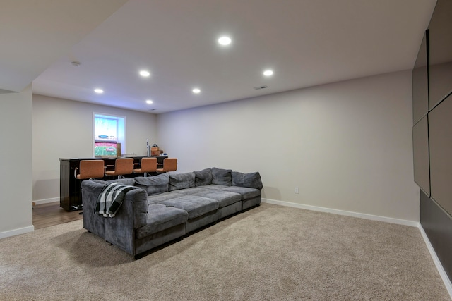 carpeted living room featuring bar