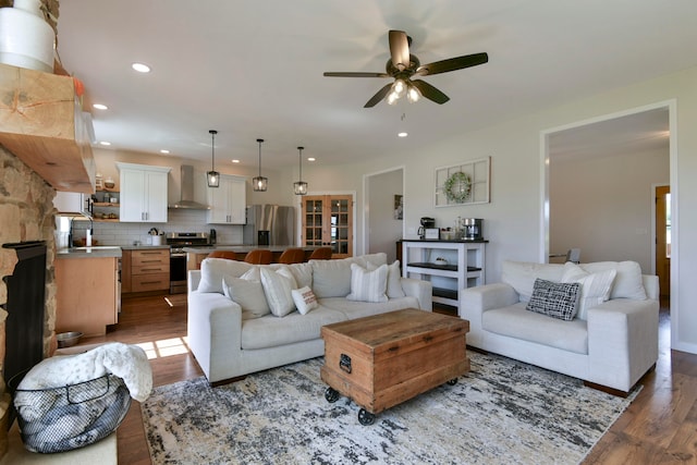 living room featuring ceiling fan, dark hardwood / wood-style floors, and sink