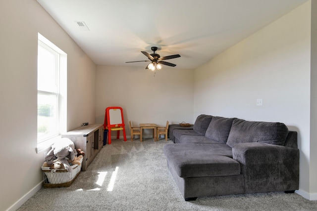 carpeted living room with ceiling fan