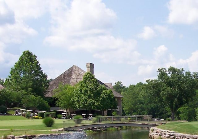 view of property's community featuring a water view and a lawn