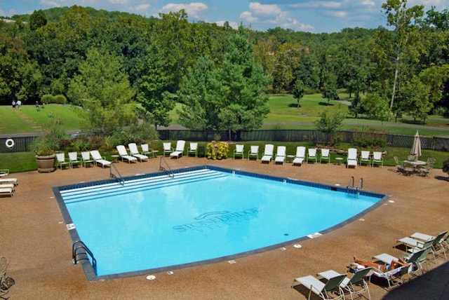 view of swimming pool featuring a patio area