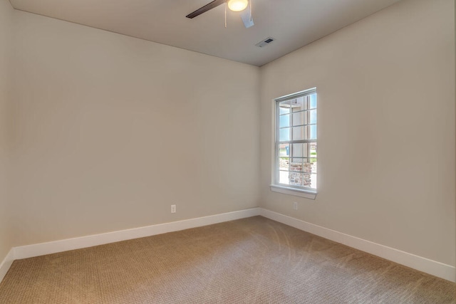 carpeted empty room featuring ceiling fan