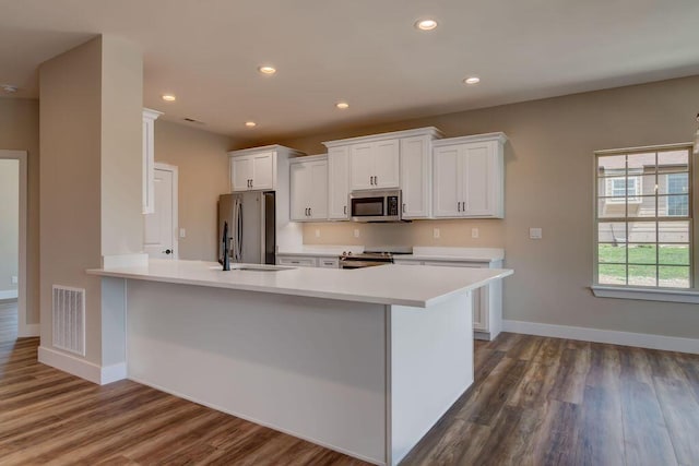 162 Mountain View Cir, Branson West, MO 65737 - kitchen with dark wood finished floors, visible vents, white cabinetry, light countertops, and appliances with stainless steel finishes