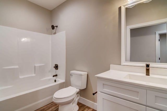 full bathroom featuring vanity, hardwood / wood-style floors, toilet, and shower / bathtub combination