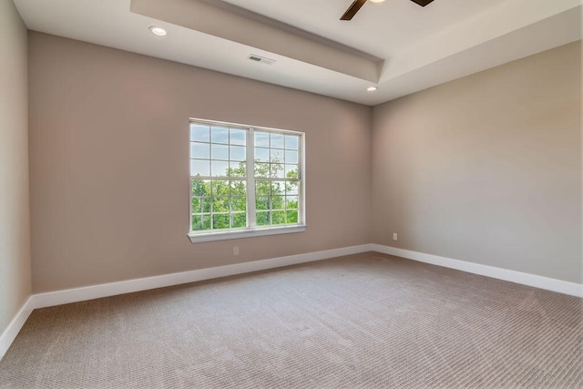 carpeted spare room with ceiling fan