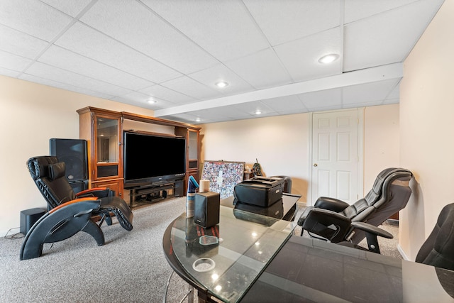 living room featuring carpet floors and a paneled ceiling