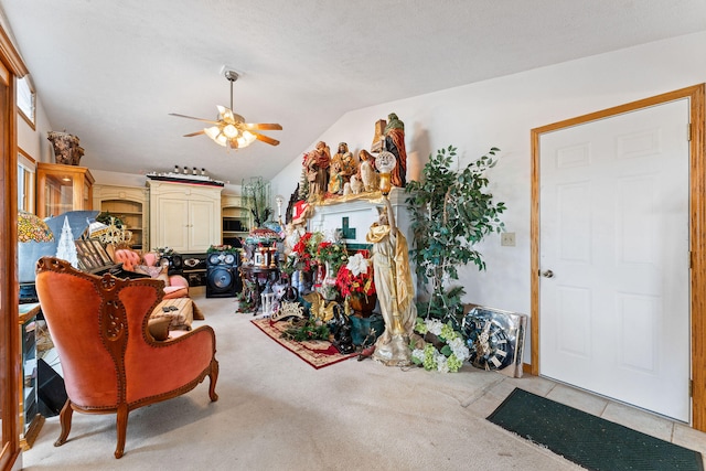 living room with ceiling fan, a textured ceiling, lofted ceiling, and light carpet