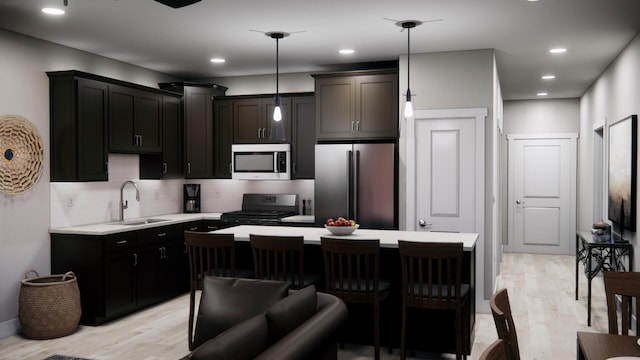 kitchen featuring decorative backsplash, sink, light hardwood / wood-style floors, pendant lighting, and appliances with stainless steel finishes