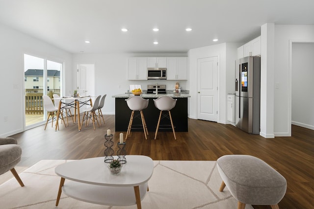 living room with baseboards, recessed lighting, and dark wood finished floors