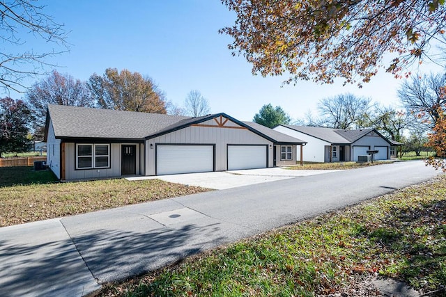 ranch-style home with a garage and a front yard