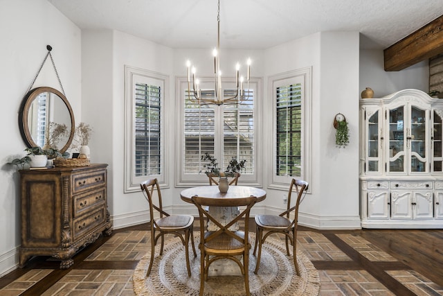 dining area featuring baseboards, a chandelier, and brick floor