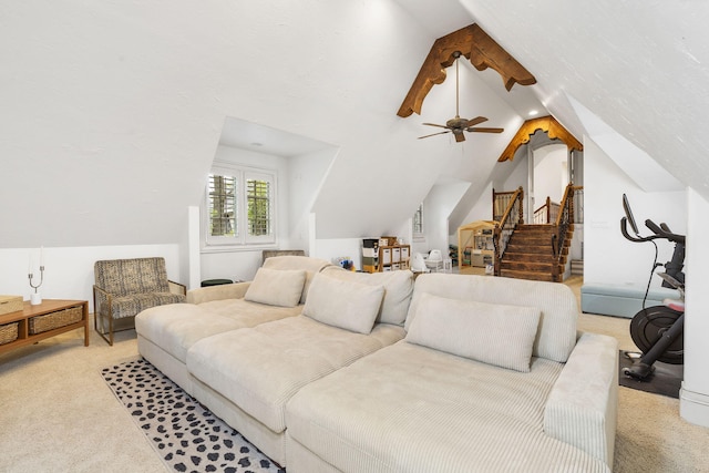 living room featuring vaulted ceiling, stairway, carpet floors, and ceiling fan