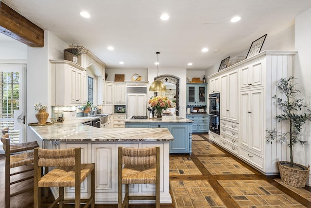 kitchen with a peninsula, recessed lighting, blue cabinetry, brick floor, and a breakfast bar area