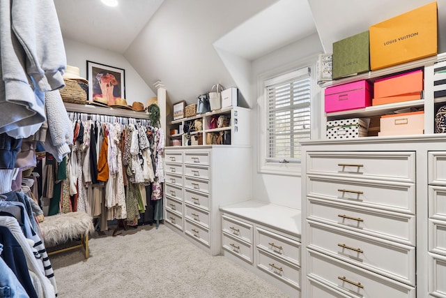 walk in closet featuring lofted ceiling and light carpet