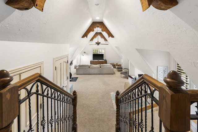 carpeted bedroom featuring vaulted ceiling, a textured ceiling, and a ceiling fan