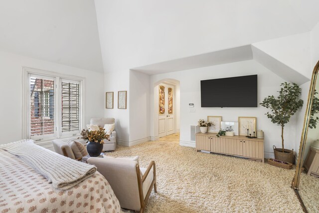 living room featuring light carpet and high vaulted ceiling