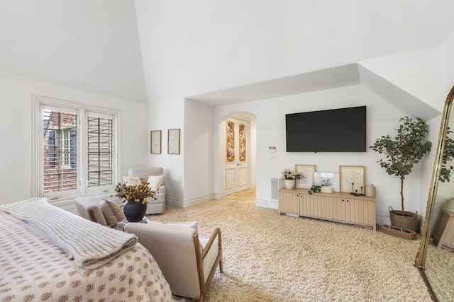living area with high vaulted ceiling, arched walkways, and baseboards
