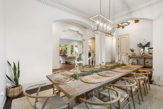 dining space with hardwood / wood-style flooring and crown molding