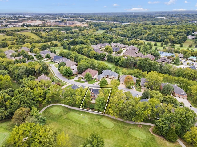 drone / aerial view featuring view of golf course and a residential view