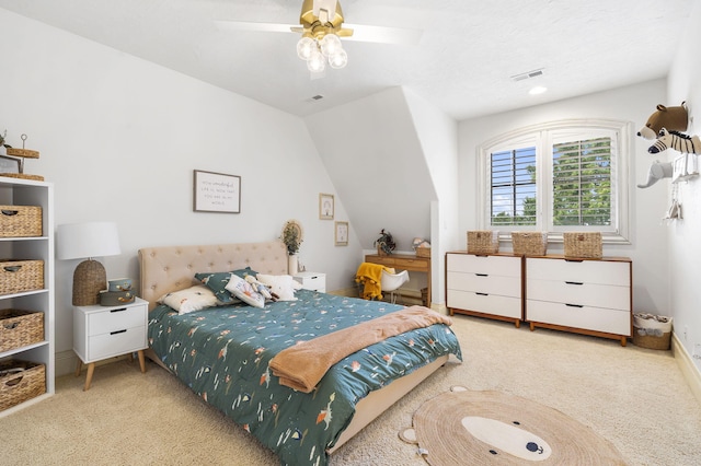 bedroom with vaulted ceiling, visible vents, a ceiling fan, baseboards, and carpet flooring