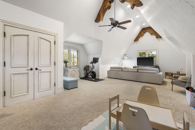 carpeted living room featuring ceiling fan and vaulted ceiling