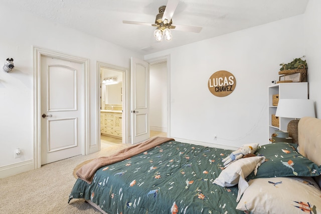 carpeted bedroom featuring ceiling fan and ensuite bath