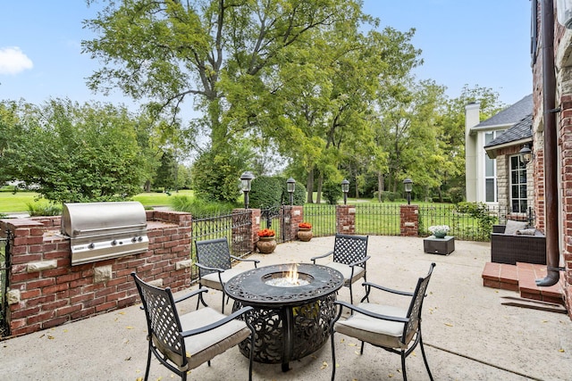 view of patio / terrace with an outdoor living space with a fire pit, an outdoor kitchen, and a grill