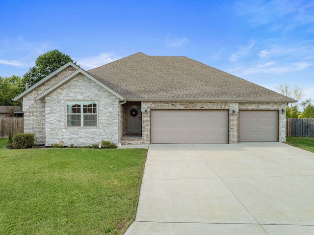 view of front of home with a front yard and a garage