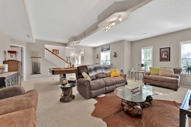 carpeted living room with billiards and a textured ceiling