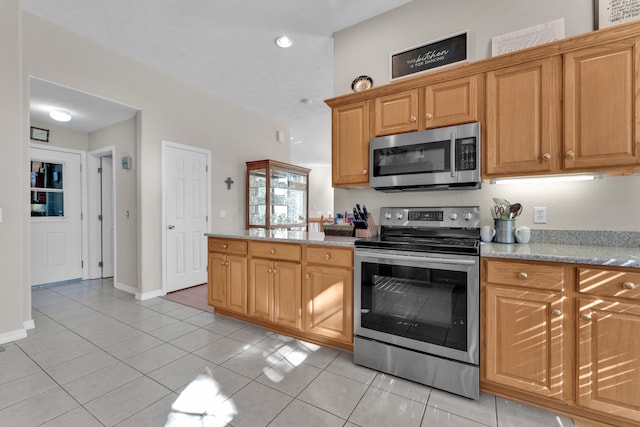 kitchen with stainless steel appliances and light tile patterned floors