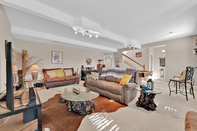 carpeted living room with beamed ceiling