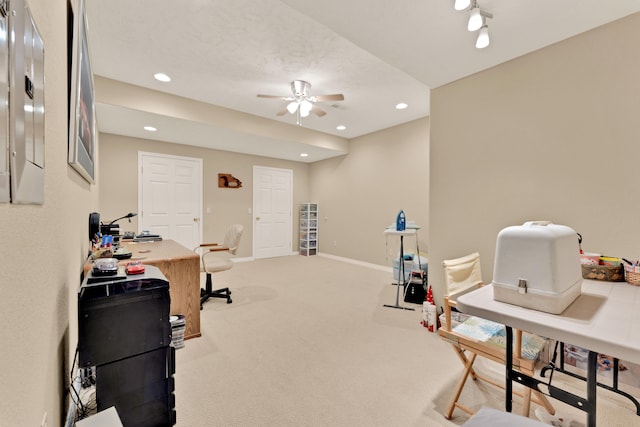 home office with carpet floors, a textured ceiling, and ceiling fan