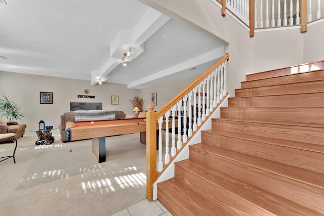 playroom with light colored carpet and beam ceiling