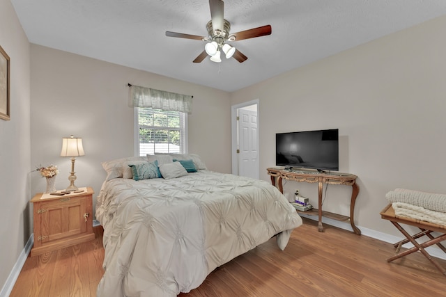 bedroom with ceiling fan and light hardwood / wood-style flooring