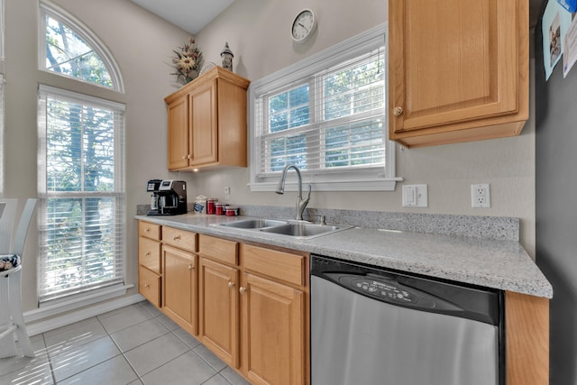 kitchen featuring light tile patterned floors, plenty of natural light, sink, and stainless steel dishwasher