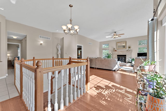 corridor featuring a notable chandelier and light hardwood / wood-style flooring