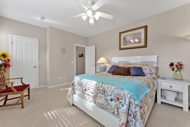 bedroom with ceiling fan and light carpet